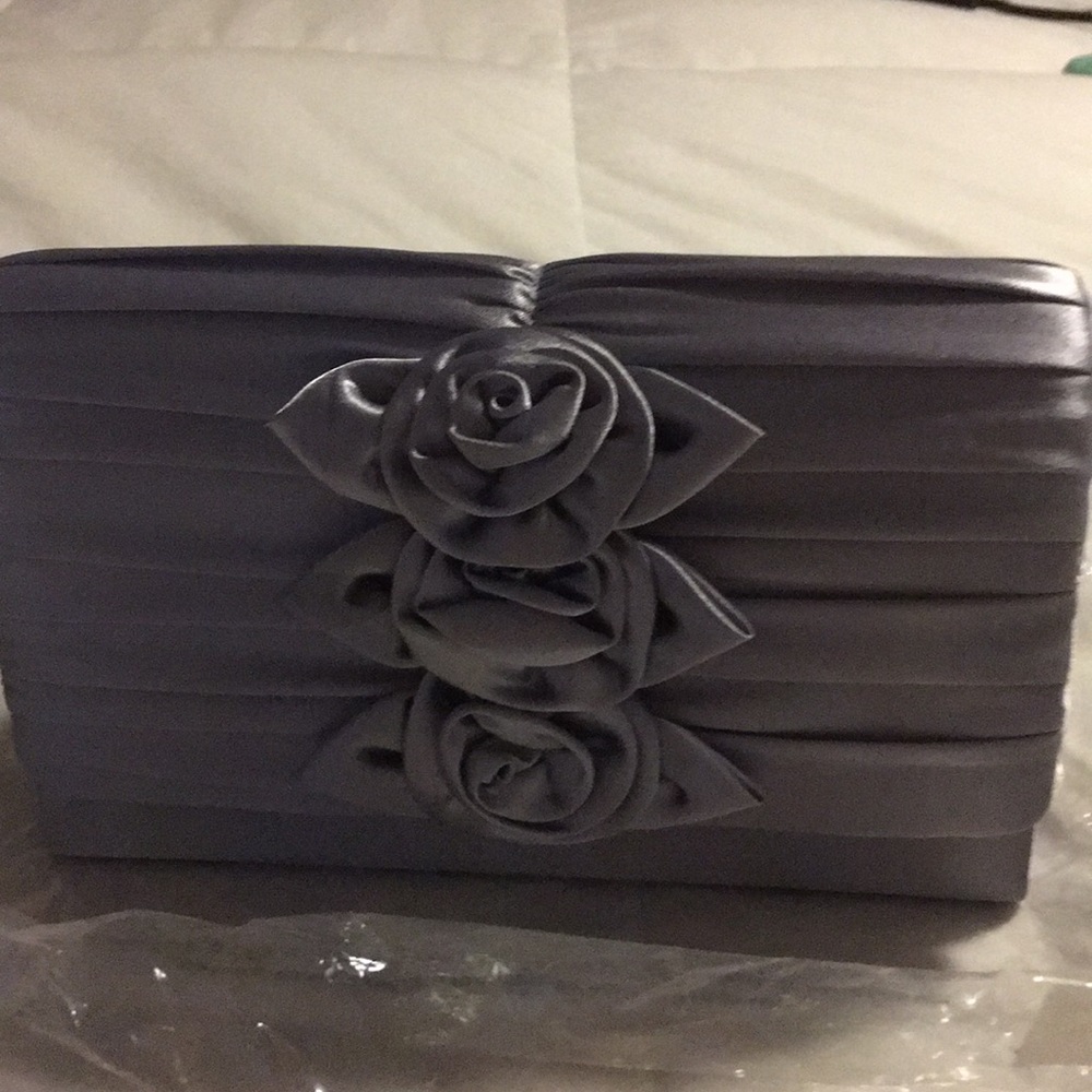 Super cute brand new silver clutch with strap.